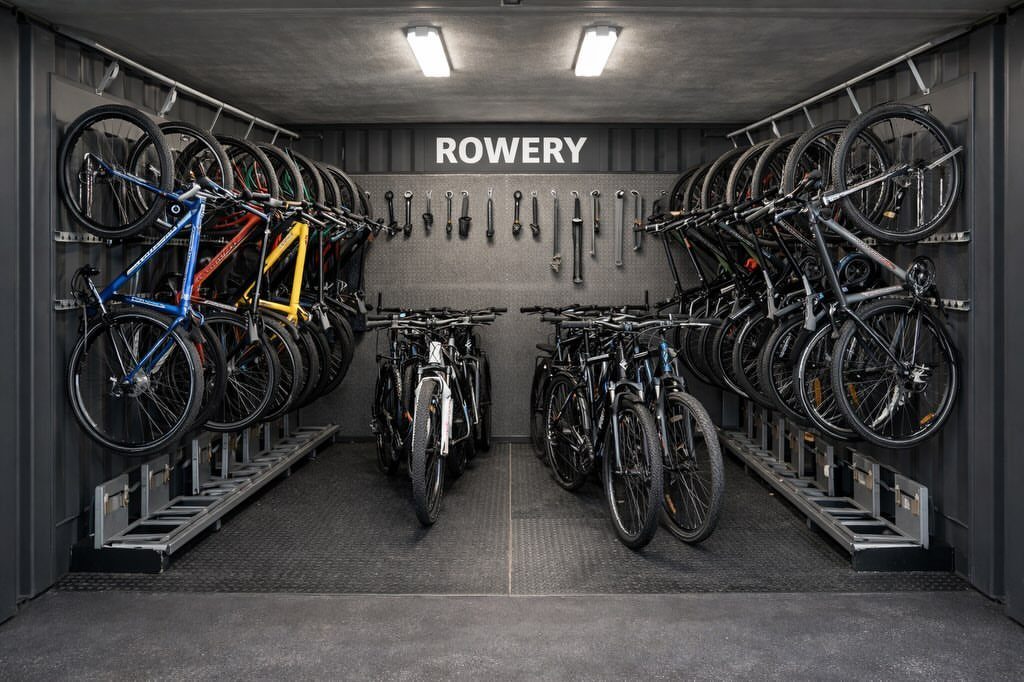 Bicycles parked in a modern, organized indoor shared building bike storage room.