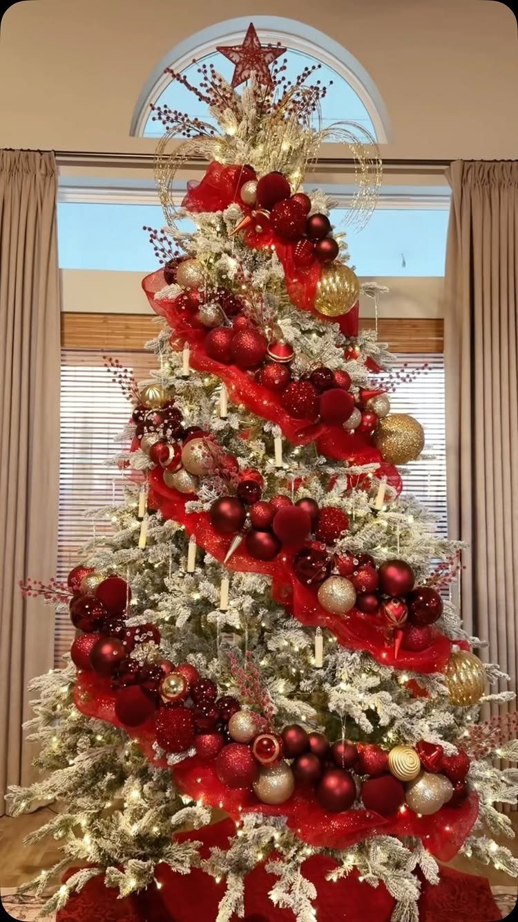 Burgundy Tree Decor: 9 Ideas Borrowed from High-End Design 6 A decorated white Christmas tree with red ornaments, gold accents, and small white candles.