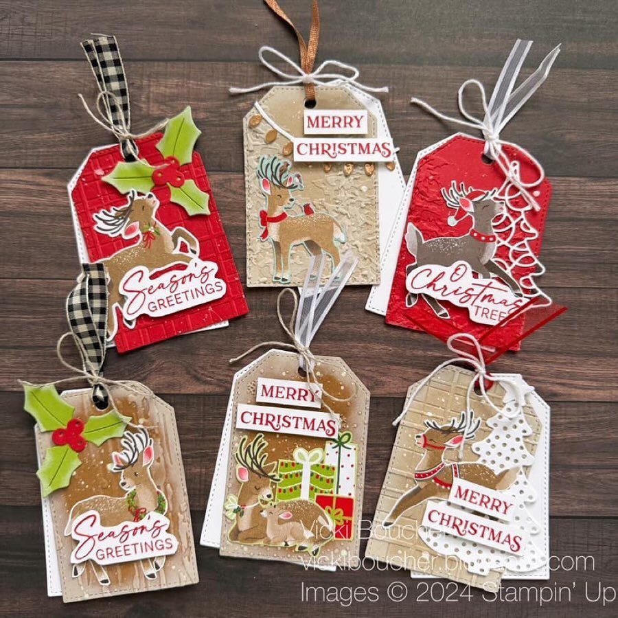 25 Christmas Art and Craft Ideas for Cards, Ornaments, and Decor 24 Six decorated reindeer themed Christmas gift tags resting on a dark wooden surface.
