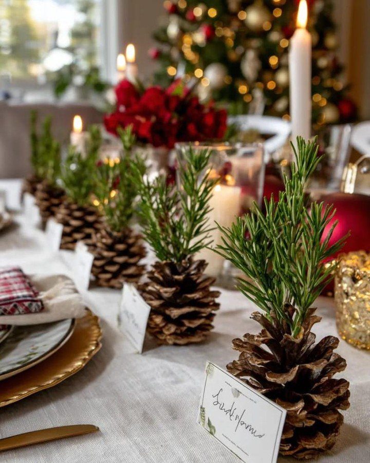 Christmas Decorations with Pinecones: 17 Ideas for Your Home 11 Pinecones with rosemary sprigs and white place cards arranged on a festive Christmas table.