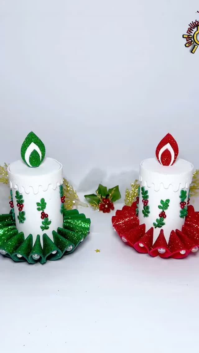 21 DIY Christmas Ornaments for Adults 11 Two handmade paper candle ornaments decorated with green and red glitter and holly patterns.