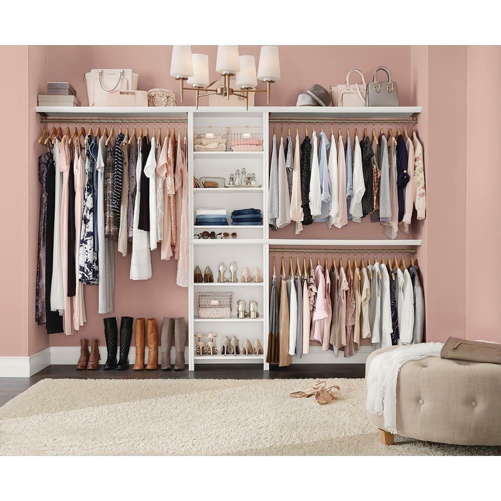 5 DIY Closet Upgrade Ideas Using Popular Wall and Modular Systems 3 White modular closet system with hanging clothes, shelving, and shoes against a pink wall.