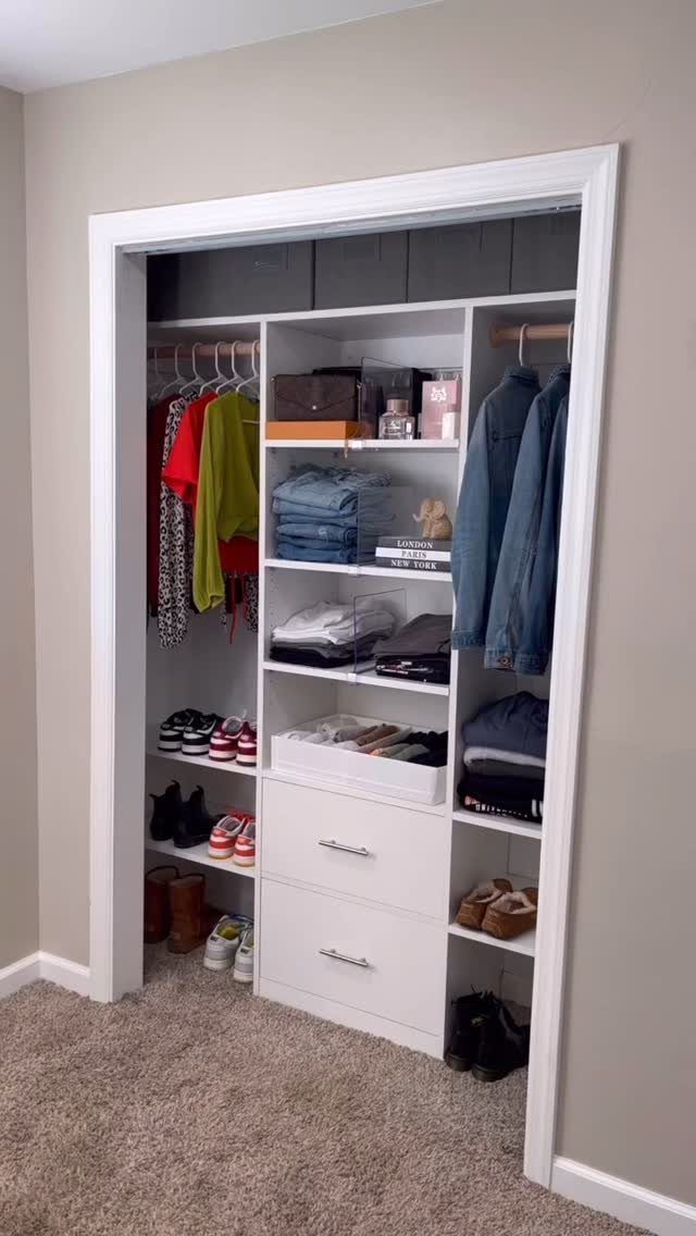 5 DIY Closet Upgrade Ideas Using Popular Wall and Modular Systems 2 White modular closet system with hanging rods, shelves, and drawers filled with organized clothing and shoes.