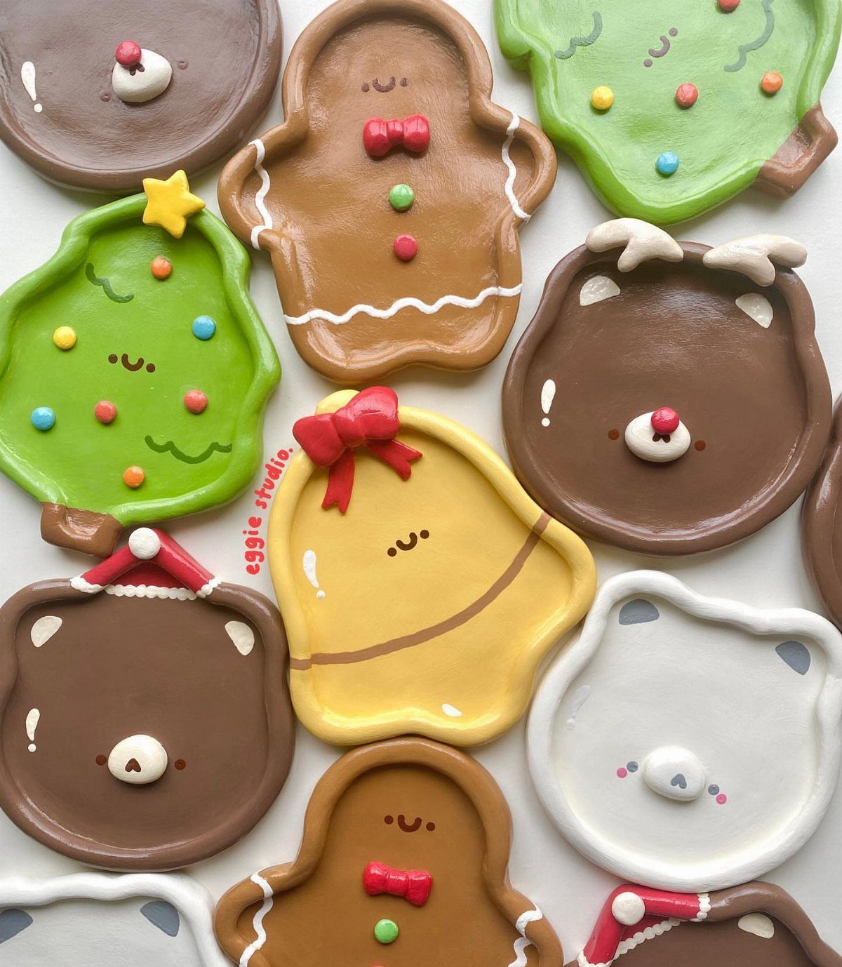 Easy Christmas Clay Ideas: 9 Projects for Handmade Ornaments 5 Various colorful clay plates shaped like gingerbread men, trees, and bears arranged on a white background.