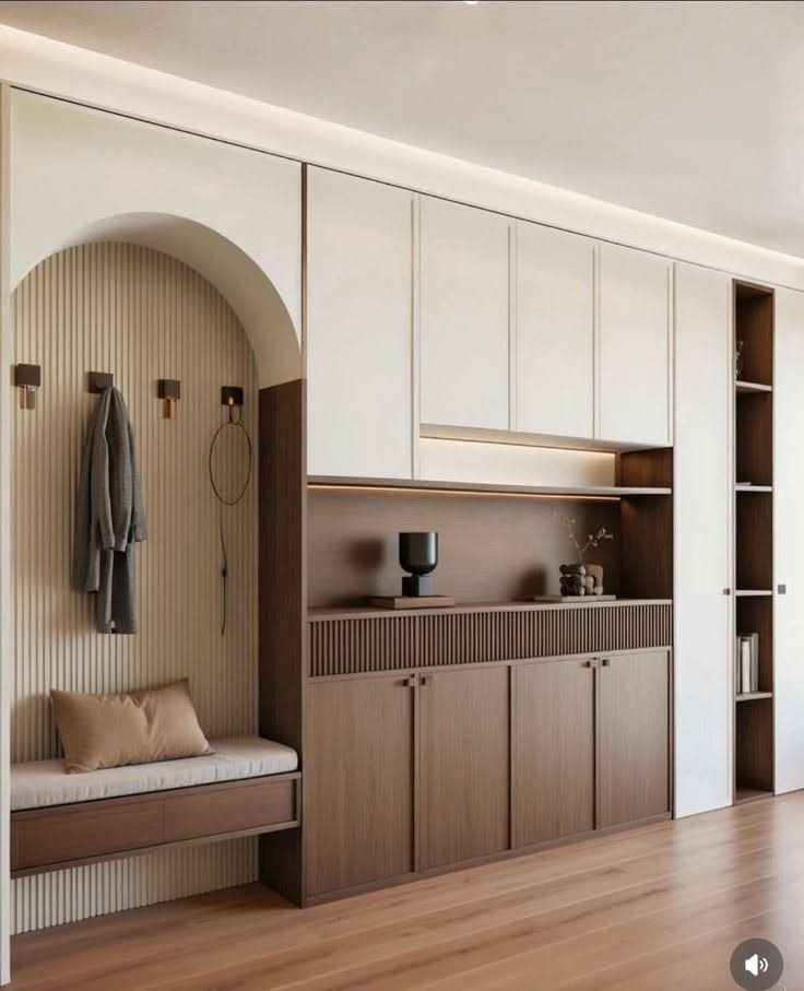 Full Height Shoe Rack Design with Seating: 6 Entryway Ideas 4 Modern entryway cabinetry featuring an arched alcove with a cushioned bench and hanging coat.