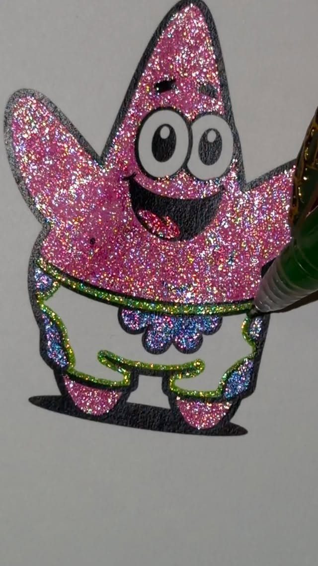 Glitter DIY Ornaments to Make 5 Ways 3 A green paint pen decorating a pink glittery Patrick Star character illustration.