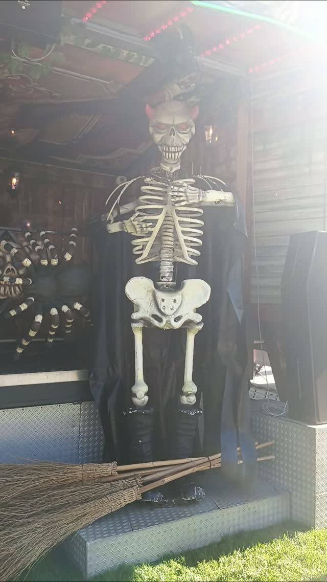 5 Goth Halloween Decor Ideas for a Properly Dark Holiday 3 A life-size skeleton wearing a black cape and red devil horns stands outdoors.