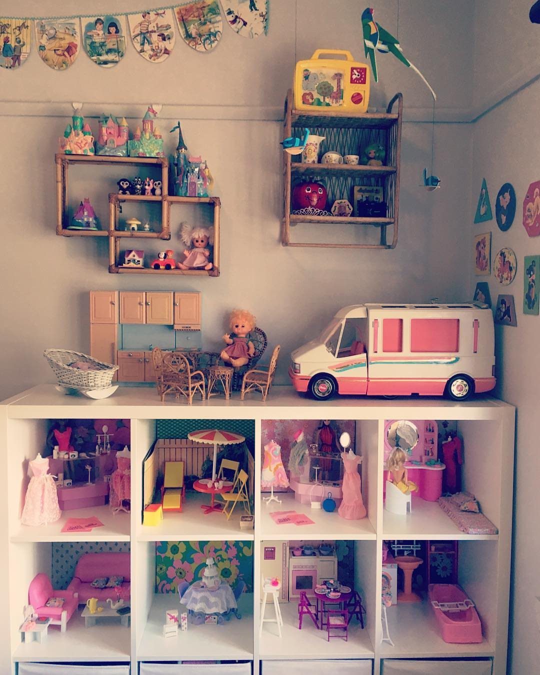 6 IKEA Kids Furniture Hacks for Better Bedrooms 5 A white KALLAX shelf unit repurposed into a detailed miniature dollhouse with various themed rooms and dolls.