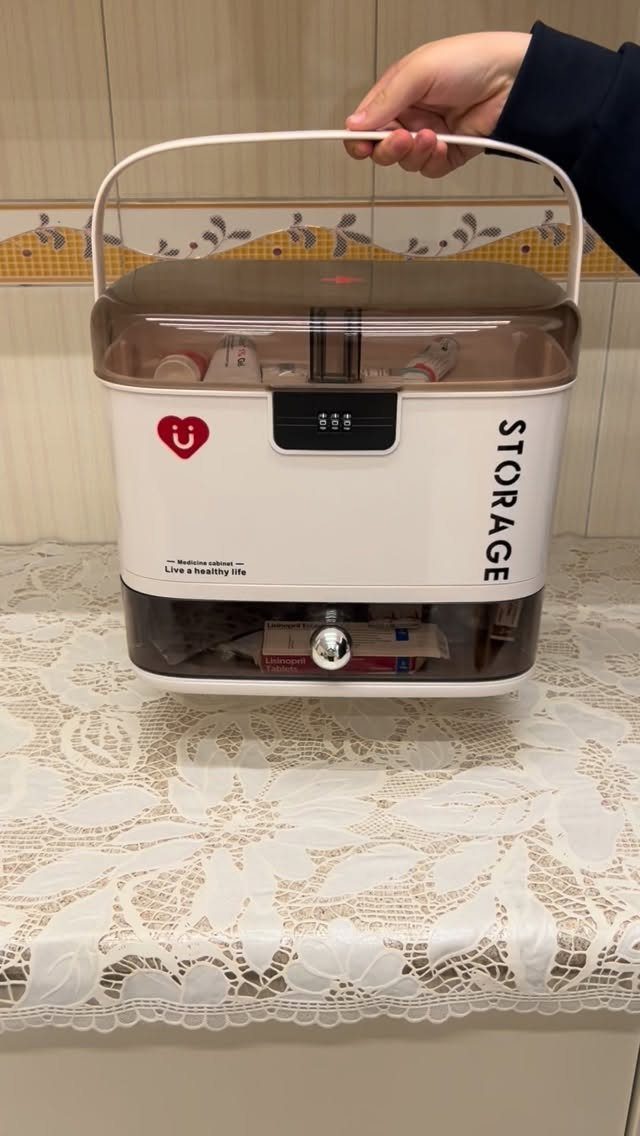 Medicine Cabinet Organization: 5 Fixes to Try in 2026 5 A white digital keypad lockable storage box with a transparent lid being held by a hand.