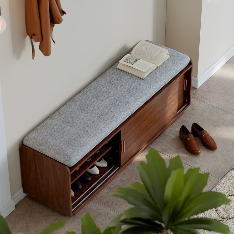 Mid Century Modern Entryway Bench With Storage: 8 Ideas 2 A wooden mid-century modern entryway bench with a grey cushion and shoe storage compartments.