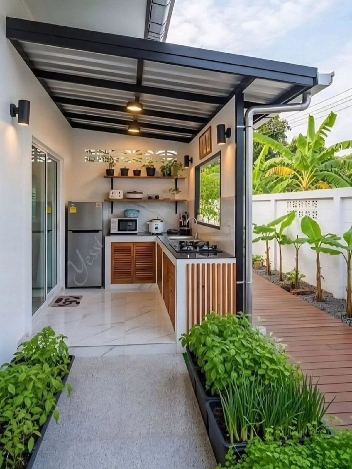 Outdoor Kitchen No Grill: 8 Ideas for Cooking Outside 2 A compact outdoor kitchen with wooden cabinets, a small stove, and greenery under a black awning.
