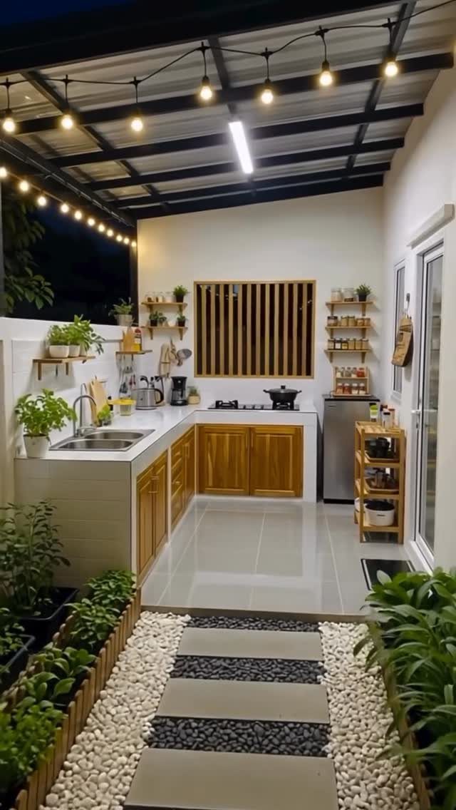 Outdoor Kitchen No Grill: 8 Ideas for Cooking Outside 4 Outdoor kitchen featuring white countertops, wooden cabinetry, a sink, and decorative string lights under a roof.
