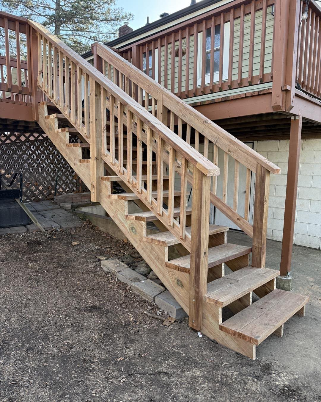 28 Outdoor Wooden Deck Ideas for Any Yard Size 23 Wooden outdoor stairs with railings connecting a raised deck to the ground.
