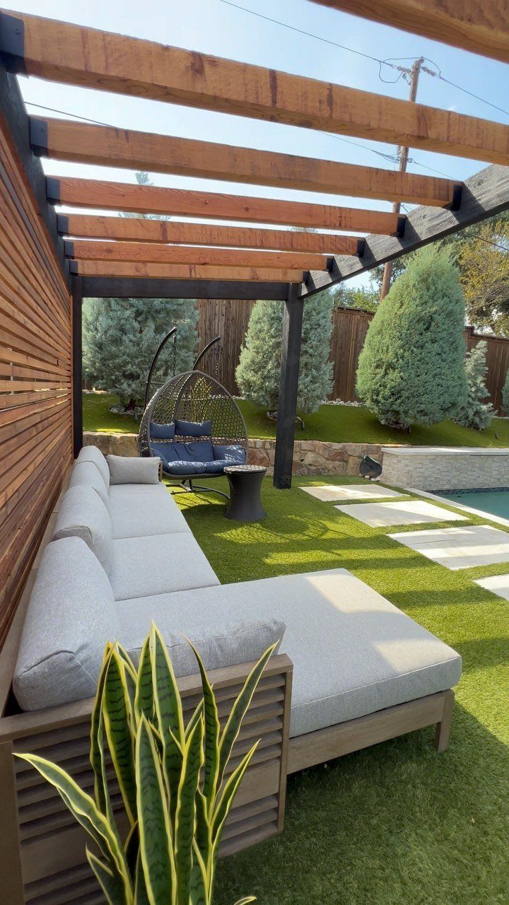 20 Patio and Deck Ideas to Make Your Yard Feel Like a Room 15 Modern outdoor lounge with a large grey sectional sofa under a wooden pergola structure.