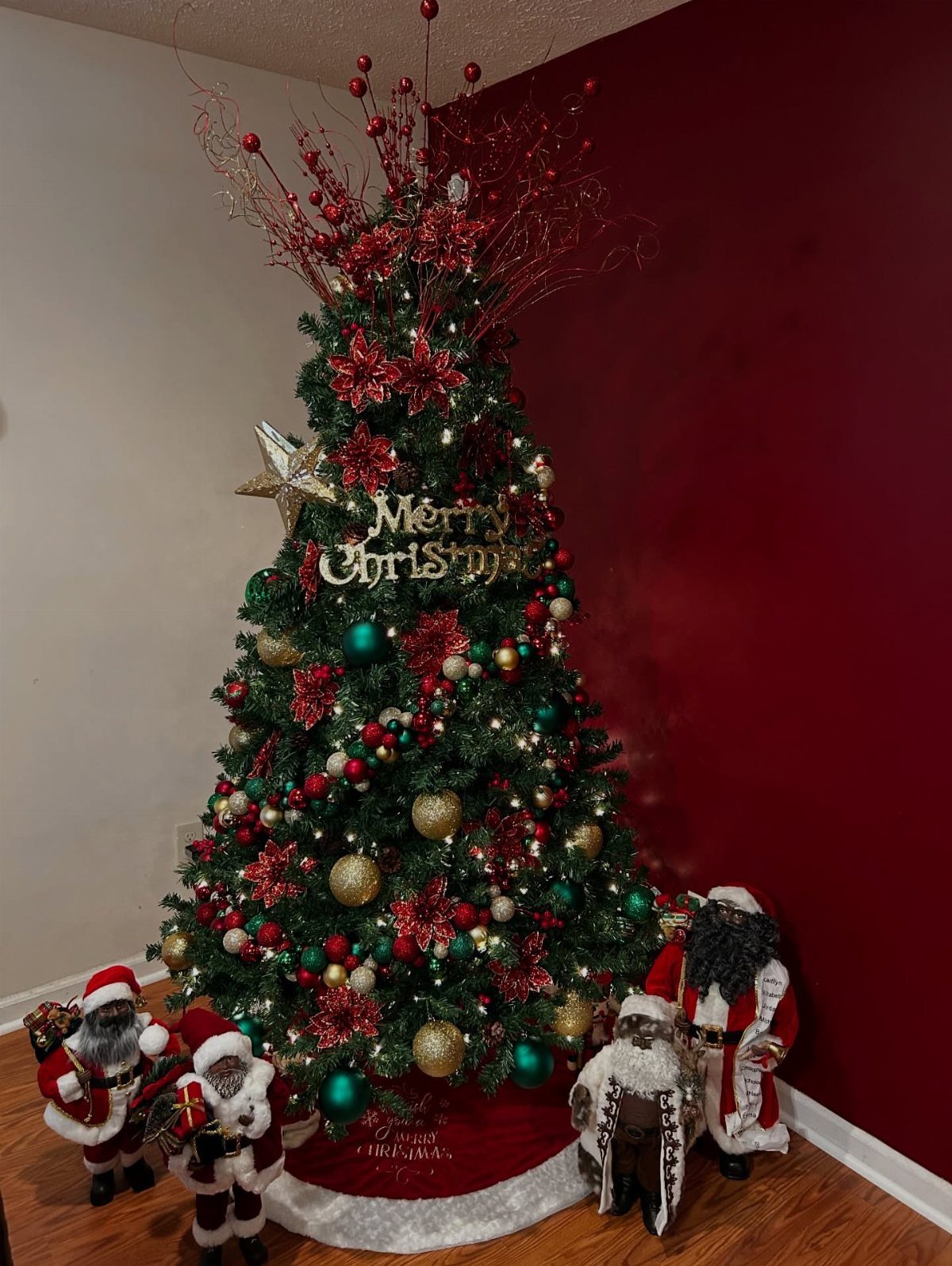 8 Red and Green Christmas Tree Ideas 7 Decorated Christmas tree with red and green ornaments and red floral picks at the top.