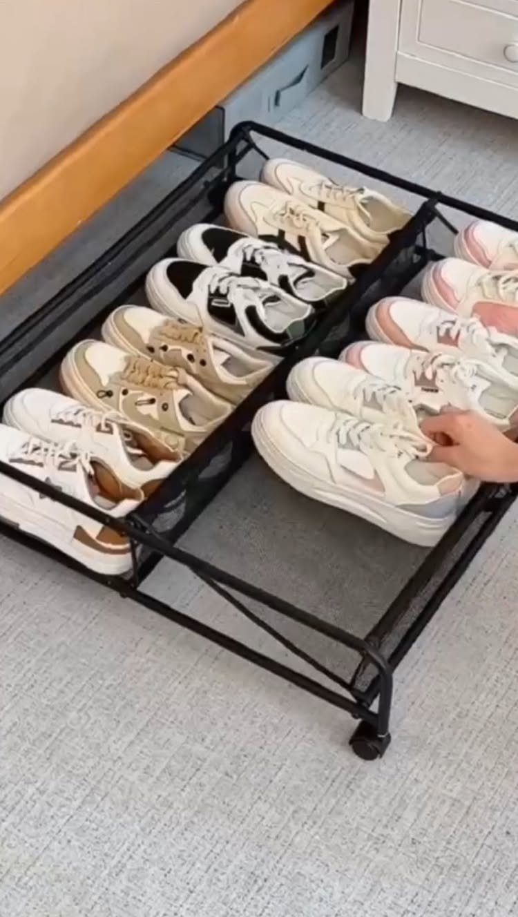 Small Sneaker Collection Closet: 5 Space-Smart Setups 2 Black metal rolling storage tray filled with various sneakers on a grey carpeted floor.
