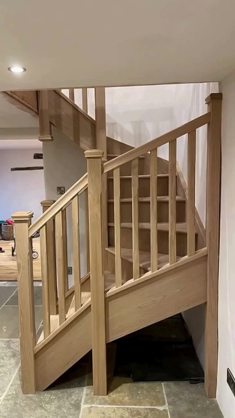 Light wood staircase featuring vertical spindles and a matching handrail in a modern home.