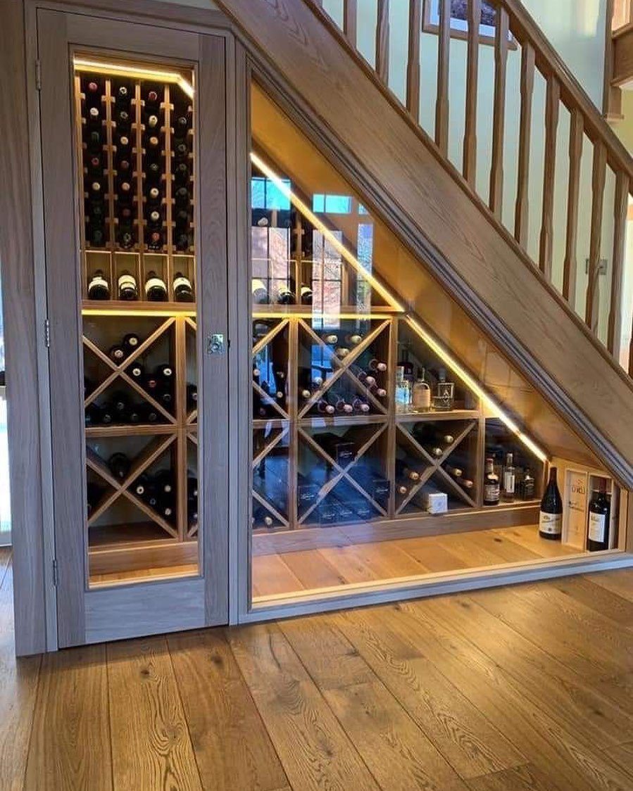 18 Under Stair Storage Design Modern Ideas for Every Home 2 Wooden wine storage cabinets with glass doors built into the space under a staircase.
